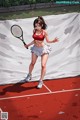 A woman holding a tennis racket on a tennis court.