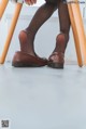 A woman sitting on a chair with her legs crossed.