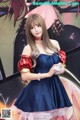 A woman in a blue dress posing for a picture.